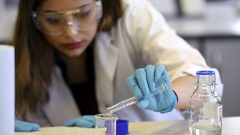 Student with chemicals in lab