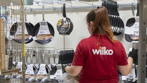 An inside view of a Wilko shop as the products on shelves are seen alongside a Wilko employee turned in a red shirt, picture taken in London on 13 August 2023