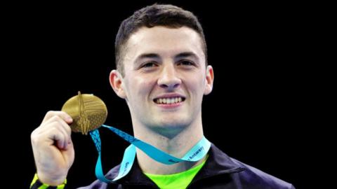 Rhys McClenaghan shows off his second world championship pommel horse gold medal