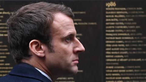 Emmanuel Macron stands by the Wall of the Righteous (Le Mur des Justes) during a visit to the Shoah Memorial on April 30, 2017 in Paris.