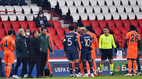 Paris St-Germain and Istanbul Basaksehir players talking to the officials