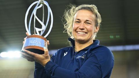 Scotland captain Rachel Malcolm with the WXV2 trophy