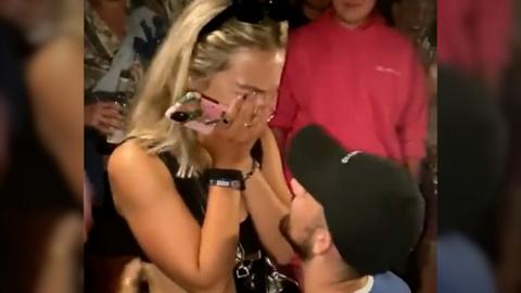 Man on one knee proposing to woman