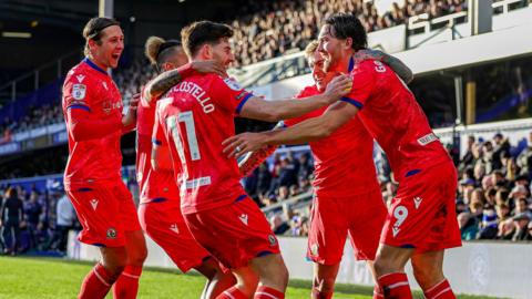 Blacburn players celebrate a goal against QPR