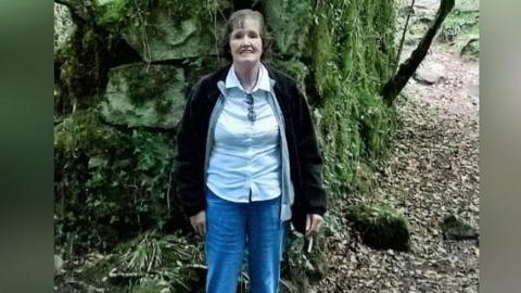 Patricia Finnie standing in a wooded area
