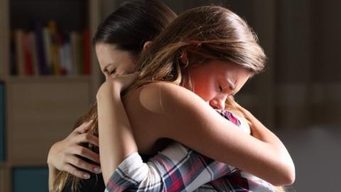 Mother and daughter embracing