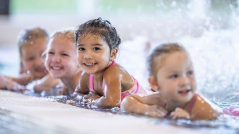 children swimming in pool