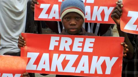 Child carrying 'Free Zakzaky' sign