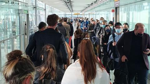 Passengers queue a Heathrow