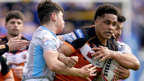 Castleford Tigers' Derrell Olpherts (right) is tackled by Leeds Rhinos' Jack Sinfield during the Betfred Super League match