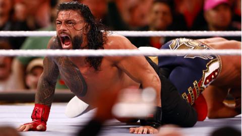 WWE fighter Roman Reigns in action