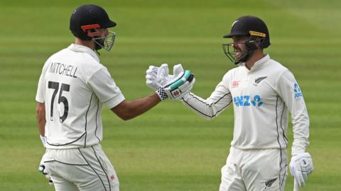 New Zealand batters Daryl Mitchell (left) and Tom Blundell (right) tap gloves