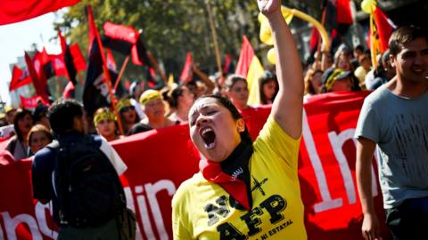 A woman shout slogans against to Pension Fund Administrators during a march against Pension Fund Administrators, demanding an end to the system due to low pensions, in Santiago, Chile, Sunday, March 26, 2017