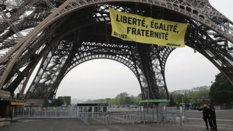 Greenpeace unfurl a giant banner on the Eiffel Tower which reads "Liberty, Equality, Fraternity" in Paris, France (May 5, 2017)