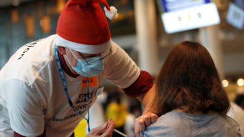 A healthcare professional administers a booster vaccine at a coronavirus disease (COVID-19) pop-up vaccination centre at Wembley Stadium in London, Britain,