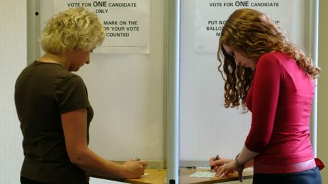 Two women voting in election