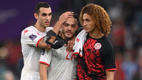 Tunisia players console Elleyes Skhiri after exiting the World Cup