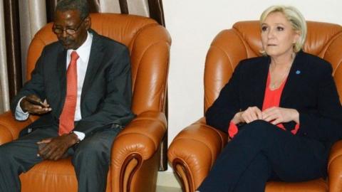 French far-right Front National (FN) party candidate for the presidential election Marine Le Pen (R) sits next to Chadian president cabinet director Mahamat Hissein