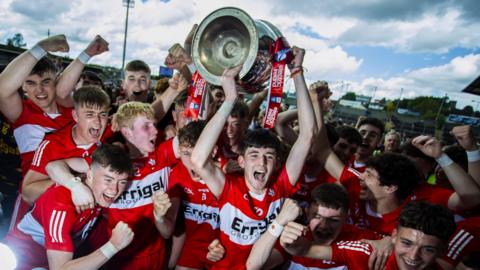 The Derry squad celebrate with the Tom Markham Cup