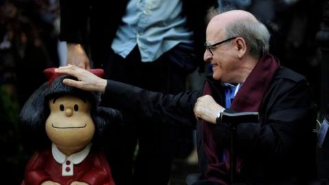 Cartoonist Joaquin Salvador Lavado, also known as Quino, touches a sculpture of his comic character Mafalda, during an opening ceremony of a park of San Francisco in Oviedo, northern Spain, October 23, 2014