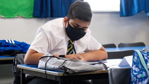 A child at school wearing a mask