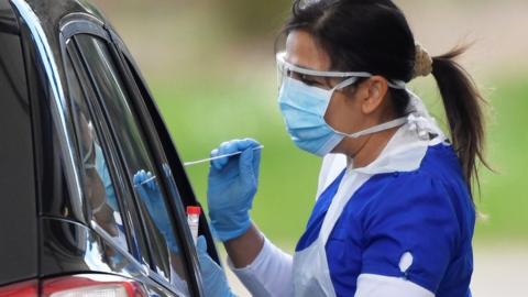 Medical staff are seen testing people at a coronavirus test centre in the car park of Chessington World of Adventures as the spread of the coronavirus disease (COVID-19) continues, Chessington, Britain,