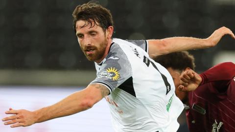 Joe Allen in action for Swansea against Northampton