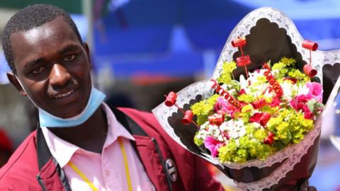 A florist seen displaying roses at his stall for Valentine's Day celebration at the streets of City Market in Nairobi.