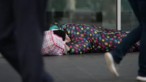 Homeless man in sleeping bag