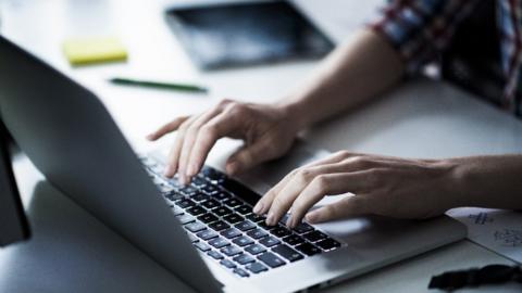 Person typing at computer