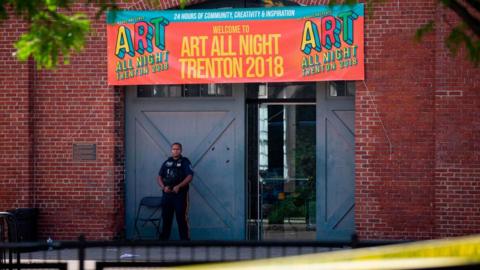 Police officer stands outside the venue, scene of the shooting, on 17 June 2018