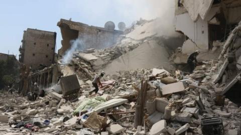 Syrian rescue workers search for victims through the rubble of a building destroyed during air bombing in eastern Aleppo. Photo: 27 August 2016