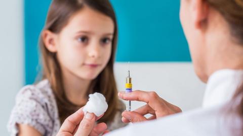 Young girl being vaccinated