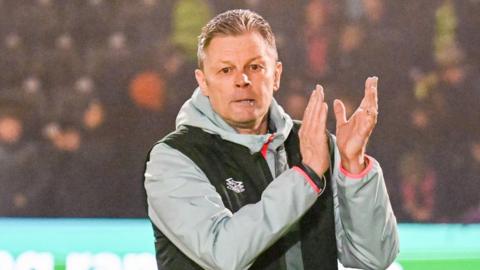 Steve Cotterill applauds fans at the end of Forest Green's draw with Wrexham