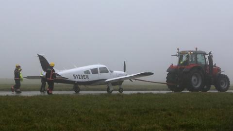 Plane being towed by a tractor