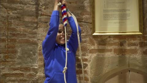 A young bell ringing girl