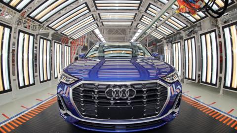 Employees work on the assembly line of Audi Q3