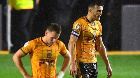 Newport players look dejected after conceding a late goal against Walsall