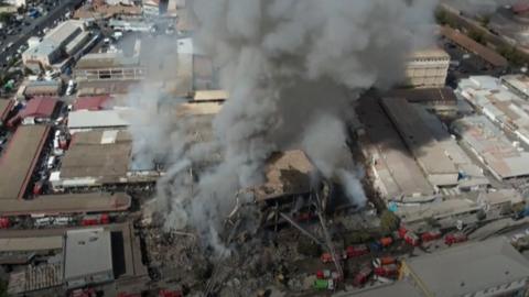 A huge plume of smoke rises from the shopping centre in Yerevan