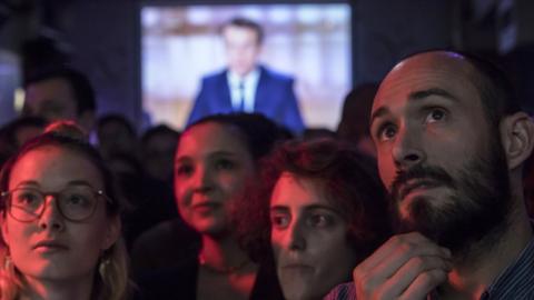 Supporters of French presidential election candidate Emmanuel Macron for the "En Marche!" movement (Onwards!) watch a live brodcast of the face-to-face televised debate between Emmanuel Macron and far-right Front National (FN) party candidate, Marine Le Pen in a bar in Paris, France, 03 May 2017.