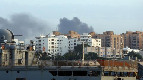 Smoke rises over the Libyan capital Tripoli after clashes on May 26, 2017