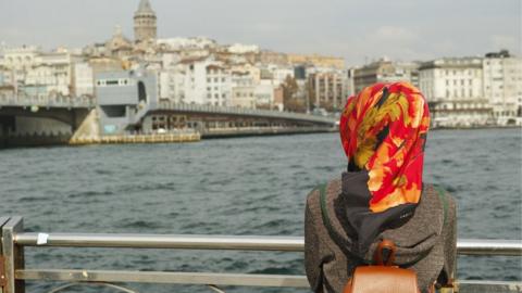 A Muslim woman looking admiring a view