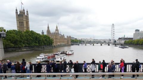 Members of the public in the queue on Lambeth Bridge, London