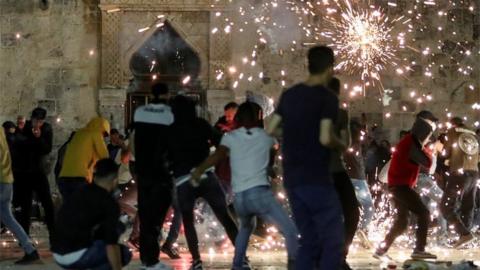 Palestinians react as Israeli police fire stun grenades near Al-Aqsa Mosque, Jerusalem. Photo: 7 May 2021
