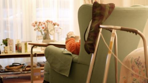 Elderly person sat in home