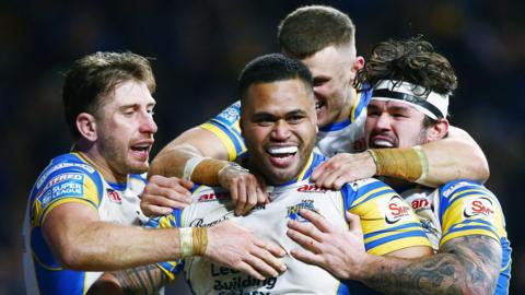 Sam Lisone is congratulated by his Leeds team-mates after scoring the winning try against Salford