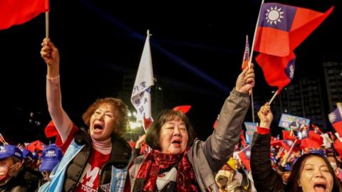 Supporters wave flags during KMT rally