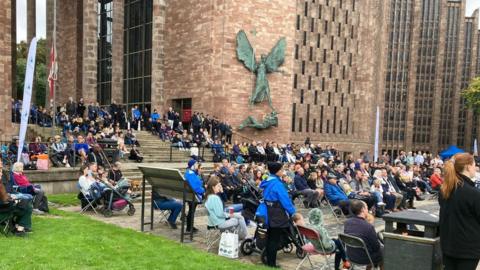 A big screen projected the funeral service outside Coventry Cathedral