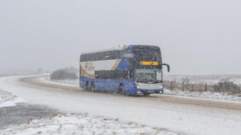 A bus travels across the Glensane Pass