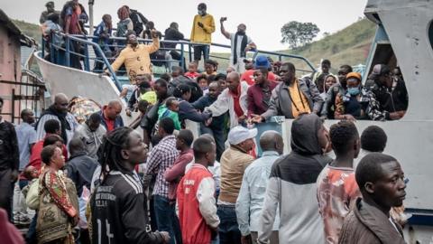 Goma residents are seen boarding a ferry after an evacuation order has been given on May 27, 2021